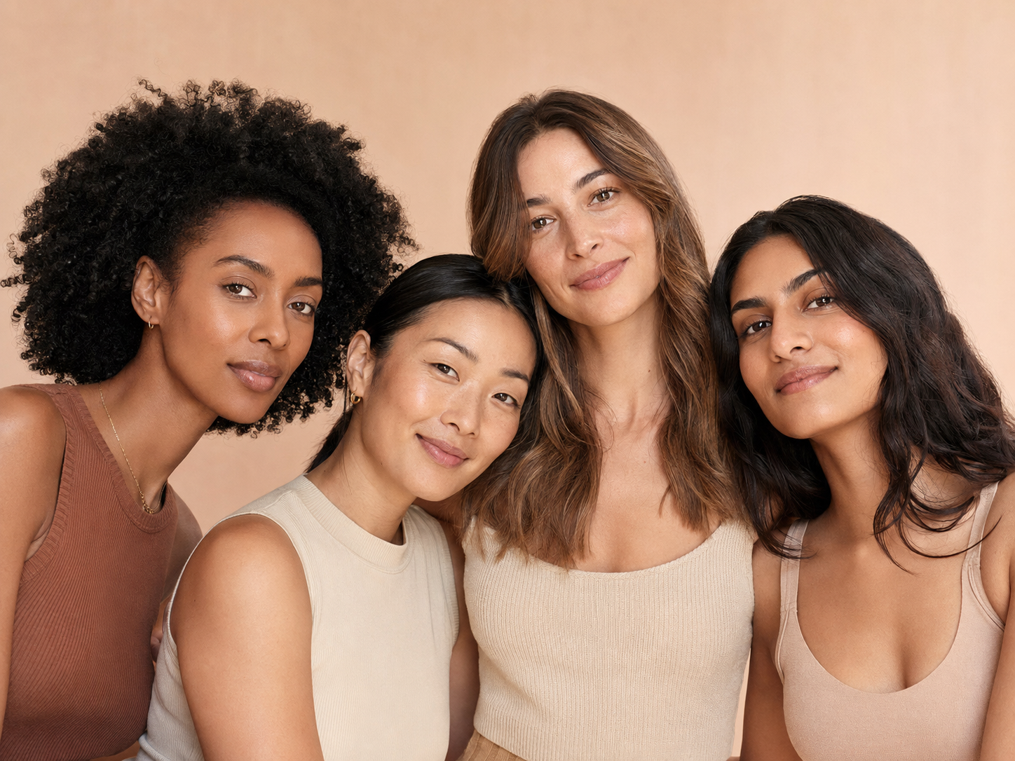 A diverse group of women in a warm beauty editorial portrait